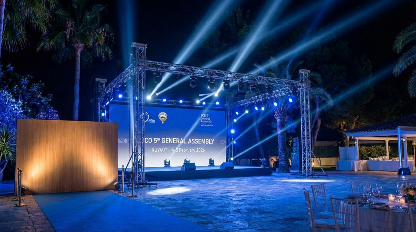 Professional outdoor stage with dramatic blue beam lighting and LED screen backdrop